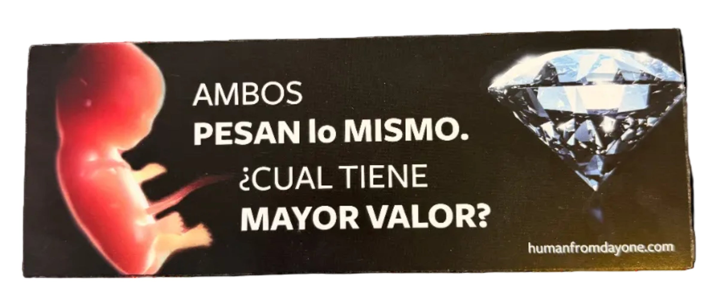 Sticker with a fetus and diamond graphic with Spanish text on a black background